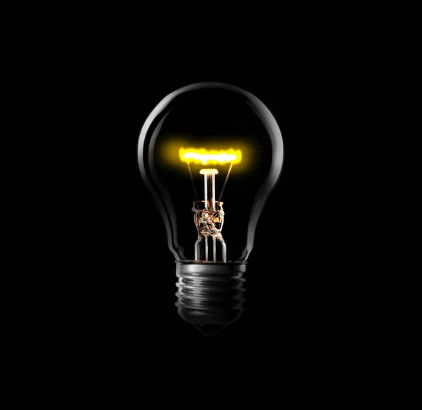 Light bulb turned on, black background.