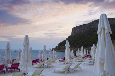 Türkiye'de yaz Akdeniz resort yakınlarındaki bir plajda şezlong. Akşam sahilde.