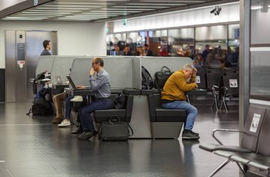 Dizüstü bilgisayarlar Havaalanı Schwechat ücretsiz Wi-Fi alanında çalışan insanlar. Viyana, Avusturya.