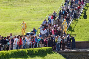 Crowd of tourists at the waterfall stairs of the Grand Cascade in the park of Peterhof. Saint Petersburg, Russia. clipart