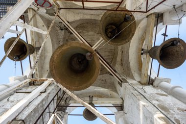 A number of different-sized bells in the Prepodobenskaya bell tower. Suzdal, Golden Ring, Russia clipart