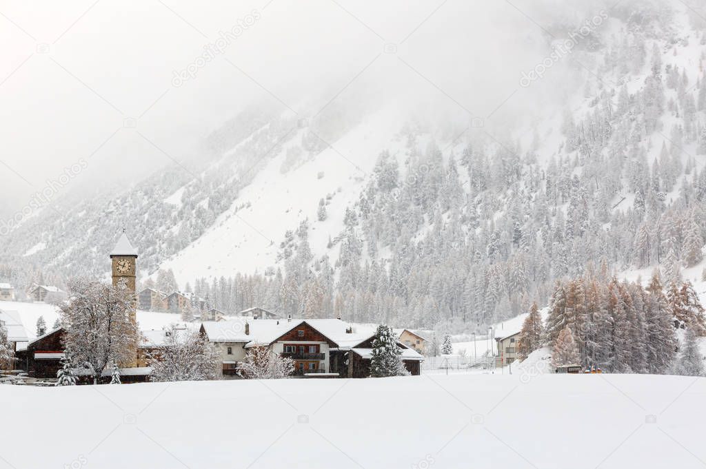 Heavy snowfall in alpine village Tschierv. Canton of Graubuenden, Switzerland.