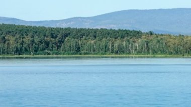 Yer göktaşı düşme. Chebarkul Gölü. Dağ orman. Panorama. Gri gökyüzü. Küçük sis. Haze.