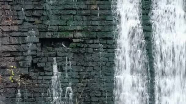 Waterfalls along an old brick wall Old micro hydro power plant. — Stock Video