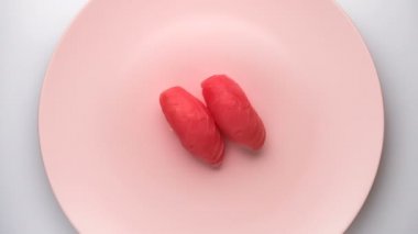 Dönen pembe tabakta iki ton balıklı nigiri suşi..