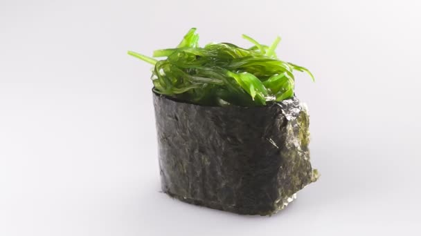 Spinning nori sushi isolated on the white background. — Stock Video