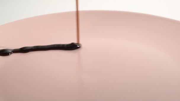 Pouring teriyaki sauce on a pink plate. Slow motion. — Stock Video