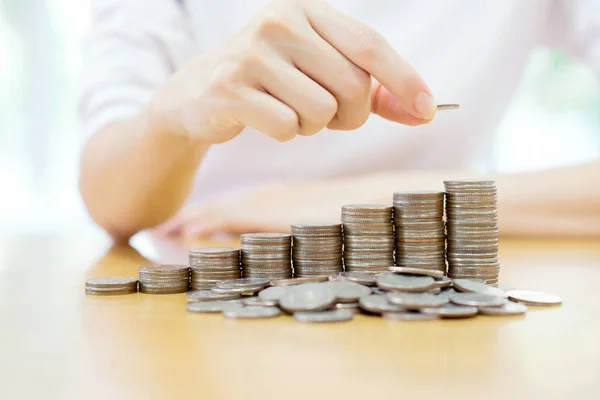 Close-up Of woman Hand Put Coins To Stack Of Coins — Stock Photo, Image