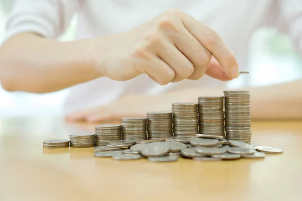 Hand put coins to stack of coins — Stock Photo, Image