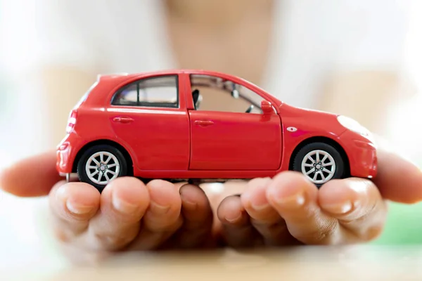 Hand with car. Auto dealership and rental concept background.