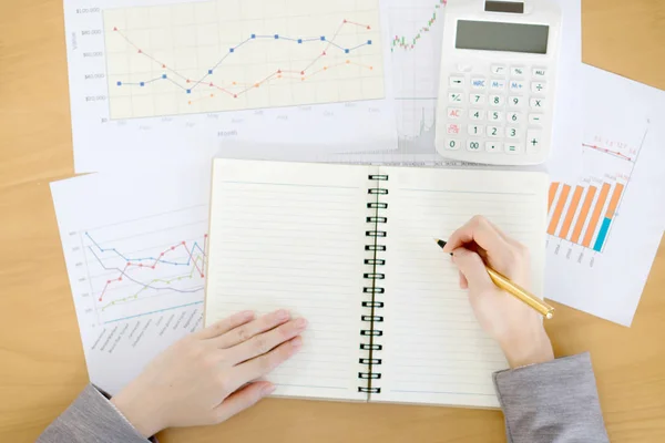 Picture of woman hand with calculator and papers — Stock Photo, Image