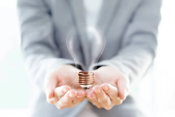 Businesswoman hold Light Bulb with soil — Stock Photo, Image