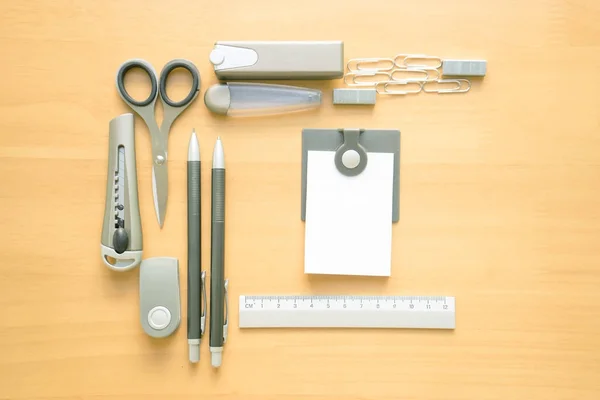 Open album with school supplies on the wooden table