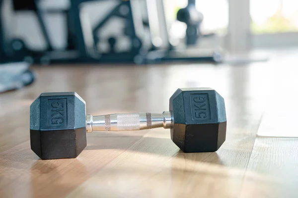 Close-up of dumbbells on the floor of home gym with sunlight thr — 스톡 사진