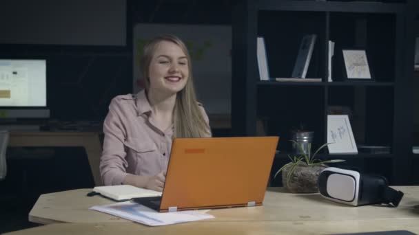 Ung kvinna avslutar arbete i office — Stockvideo