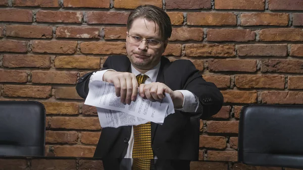 Businessman tearing a contract in pieces
