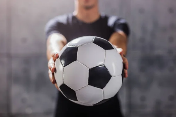 Man holding soccer ball in hands