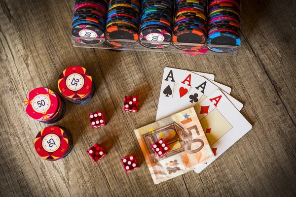 Closeup of four aces with chips and dice, gambling concept