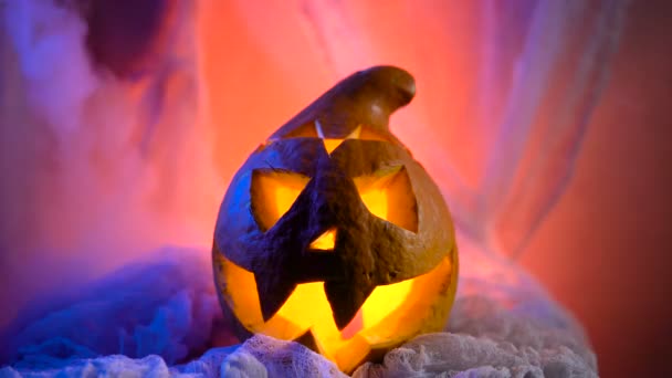 Scary Halloween Pumpkin looking through the smoke. Glowing, smoking monster pumpkin from depths of hell — Stock Video