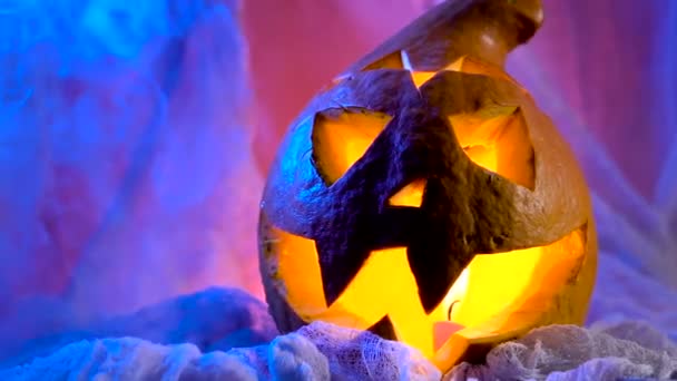 Pumpkin head lit from within, her eyes, nose and mouth flickering candle light. All Saints Day will decorate this attribute. — Stock Video