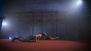 Aynı zamanda zor crossfit egzersiz yaparak iki sporcular.