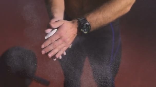 Athlete preparing a hands for exercises with barbell. — Stockvideo