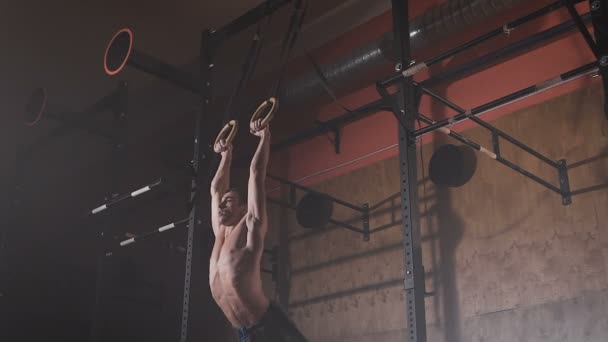 Jovem atleta fazendo exercícios nos anéis . — Vídeo de Stock