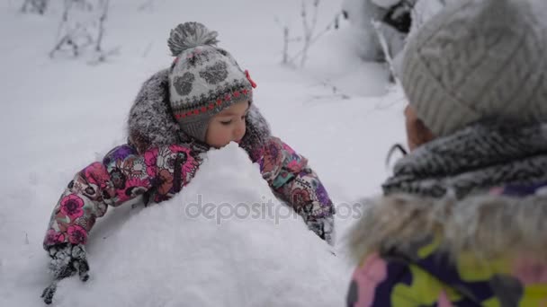 Mère avec la fille dans le bois. La fille l'enfant passe joyeusement du temps à se précipiter boules de neige. Repos d'hiver, apporter beaucoup d'émotions vives à la, l'humeur s'améliore instantanément . — Video