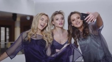 Üç mutlu arkadaşlar komik selfie mutlu bir şekilde gülümseyerek yapıyoruz. Seksi şık kızlar yılını kutlayan ve doğum günü partisine katılan. Bayanlar rahatlatıcı ve birlikte vaktinizi.