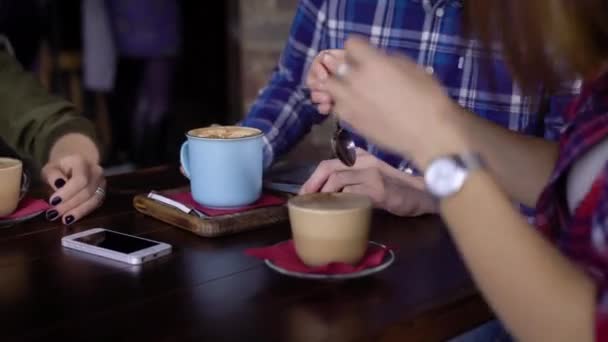 Close-up, mesa no restaurante ou café. Mulheres e homens mãos, copos com café e bebidas, smartphone na mesa . — Vídeo de Stock