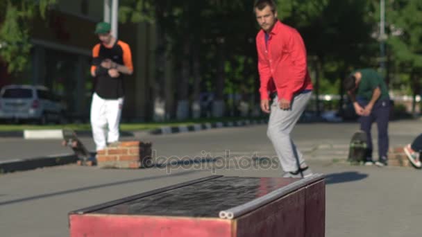 Man practicing with skateboard in park jumping on stand — Stock Video