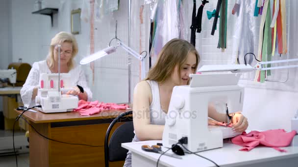 Κορίτσι και γυναίκα coworking και ράψιμο στο ραφείο χρήση μηχανημάτων — Αρχείο Βίντεο