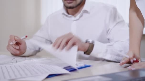 General manager of a company is signing documents and giving it to secretary in a modern office in daytime — Stock Video