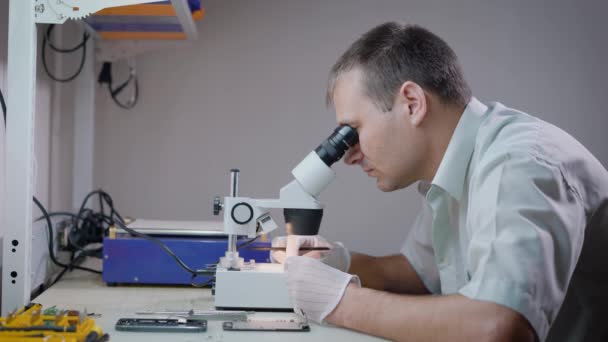 Technicien utilise un appareil optique en atelier .