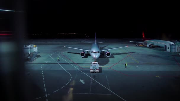 Illuminated aerodrome in night time with planes prepared for leaving — Stock Video