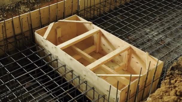 View of metal armature of carcass and wooden formwork for constructing a reinforced concrete structures — Stock Video