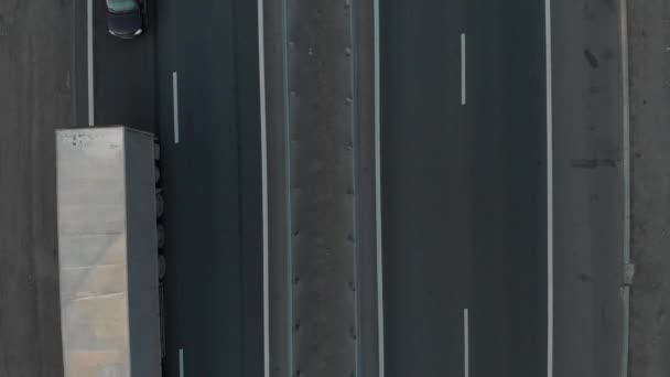 Aerial view. Intercity highway section. Cars and wagons drive along a four-lane road. — Stockvideo