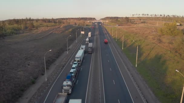 Aerial view. Intercity highway section. Congestion on the road. Cars and wagons are standing in a long traffic jam. Slow moving vehicle. — Stock Video