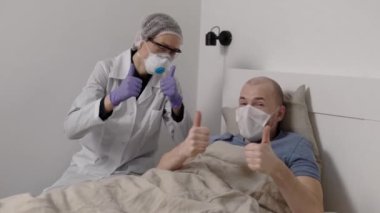 Funny nurse and patient. Joyful doctor and man in the medical ward. People rejoice in recovery.