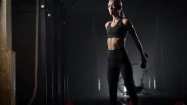 Beautiful young blonde is engaged in fitness. The woman performs exercises to maintain the figure. Slender body of a young girl. Healthy