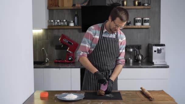 Mio marito cucina biscotti nella sua cucina. Il cuoco utilizza i moduli per pan di zenzero . — Video Stock