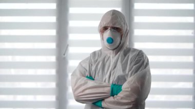 Salgın Covid-19. Koruyucu kıyafetli bir virüs uzmanı portresi. Bir erkek epidemiyoloji uzmanı enfeksiyonla savaşmaya hazır..
