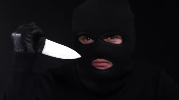 En förfärlig brottsling som bär mask och håller i en kniv. — Stockvideo