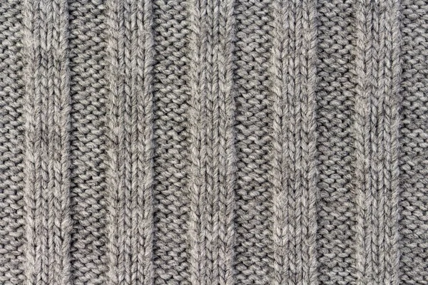 Tejer. Textura de tejido de punto gris rayado vertical, fondo de patrón de punto Imágenes de stock libres de derechos