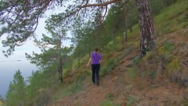 Chica corre por la ladera de la montaña — Vídeo de stock