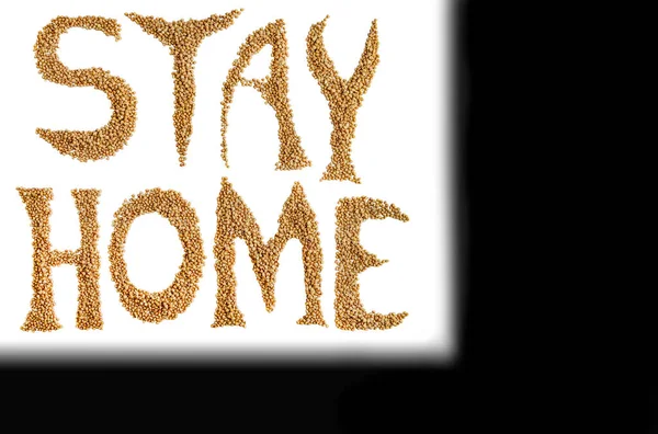 Stay At Home message made of buckwheat on white background. Motivation quote Stay At Home for stay-at-home order mode. isolated