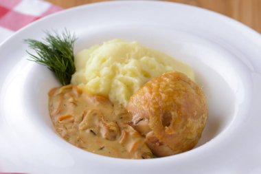 Geleneksel mutfak, soslu patates püresi, et ve dereotu ekose arka planda beyaz bir tabakta servis edilir.