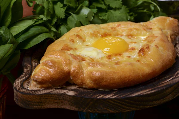 Georgian traditional cuisine. Ajarian traditional flatbread khachapuri. Open pie with mozzarella cheese and egg — Stock Photo, Image