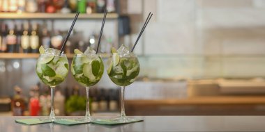 Bardaki bir masada limonlu ve buzlu taze içecekler. Boşluğu kopyala.