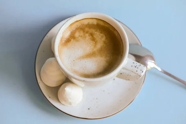 A cup of coffee latte or americano in a white cup isolated on light pastel blue background. — 스톡 사진